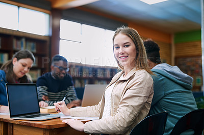 Buy stock photo Cropped portrait of a university student sitting in the library