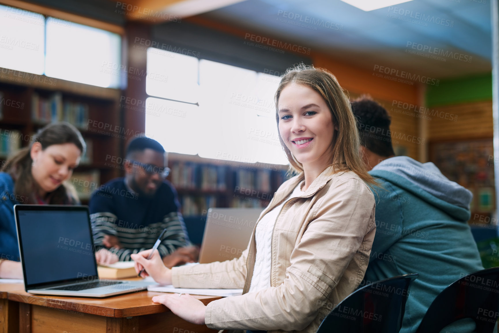 Buy stock photo Woman, student and portrait in library with group, learning and notes at campus, pride and diversity at college. Person, education and development with pc for scholarship, study and smile in Canada