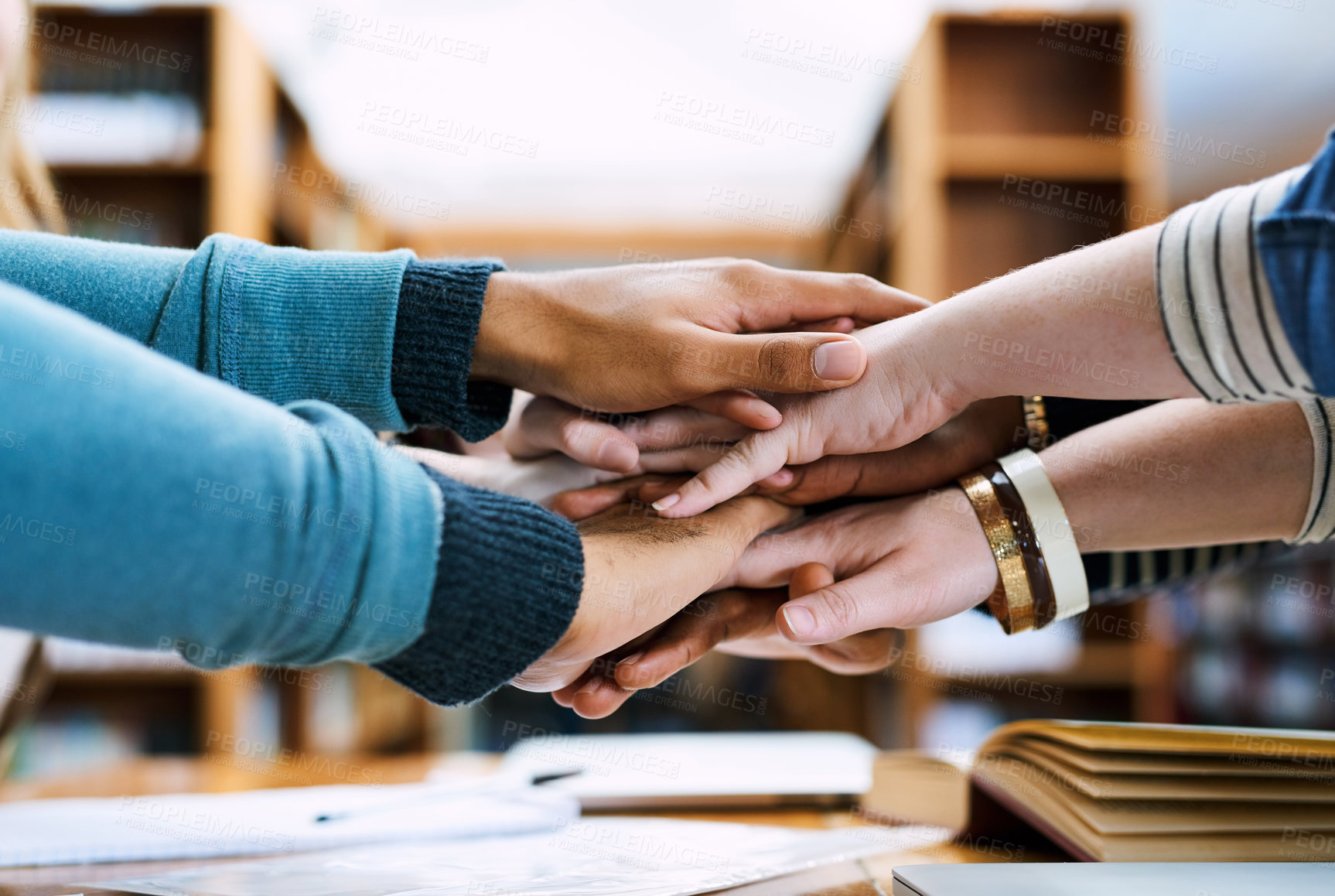 Buy stock photo Hands, stack and group of students for learning, books or solidarity for goal, exam or education. People, huddle or scrum for motivation, trust or study for development in library, hall or university