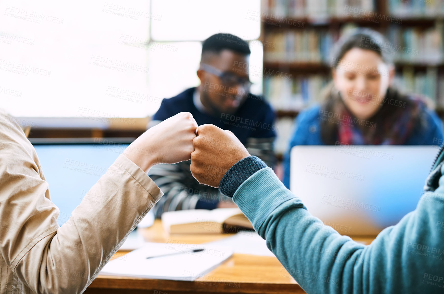 Buy stock photo Hands, students and fist bump in library for education, motivation and celebration with group at campus. People, connection and success with solidarity, learning or goal for scholarship at university