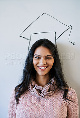 Buy stock photo Cropped portrait of a young university student standing against a whiteboard with a graduation cap drawn on it