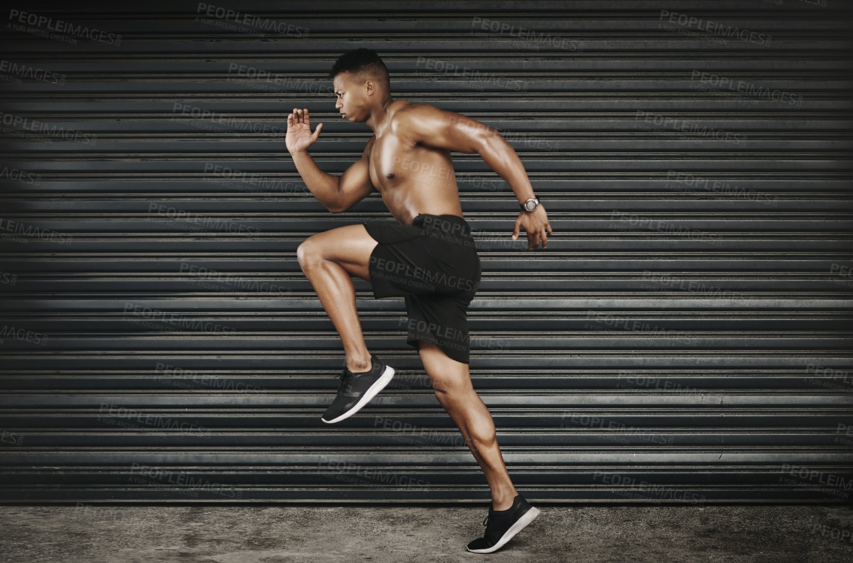 Buy stock photo Shot of a fit and shirtless young man running