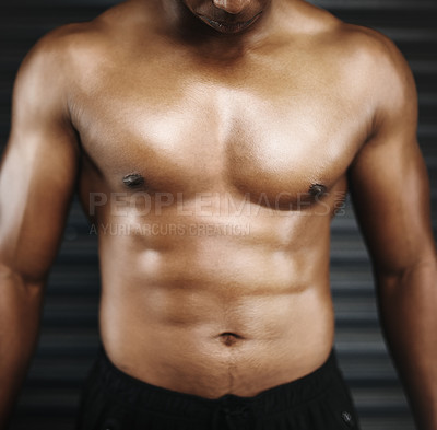 Buy stock photo Cropped shot of a shirtless man with defined abs
