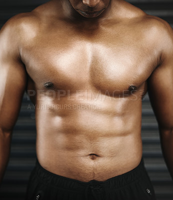 Buy stock photo Cropped shot of a shirtless man with defined abs