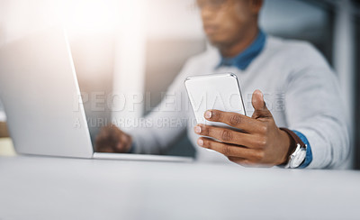 Buy stock photo Laptop, phone and hand of man at desk for communication, networking or online research at tech startup. Computer, smartphone and businessman with internet, connection and career in web management
