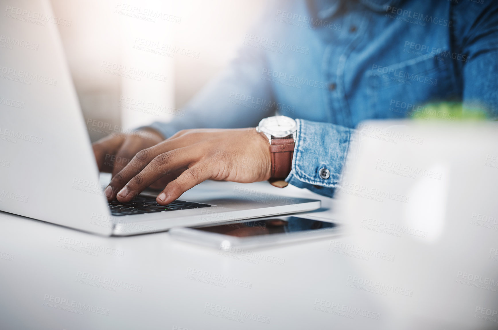 Buy stock photo Closeup shot of an unrecognizable businessman using a laptop in an office