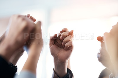 Buy stock photo Cropped shot of a group of unrecognizable businesspeople holding and raising their hands in the office