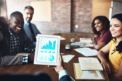 Buy stock photo Shot of a group of businesspeople analyzing graphs in an office