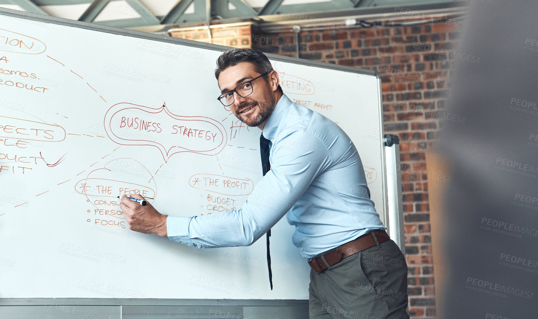 Buy stock photo Shot of a mature businessman using a whiteboard during a presentation in an office