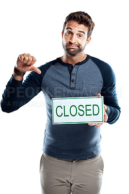 Buy stock photo Studio portrait of a handsome young man holding a closed sign against a white background