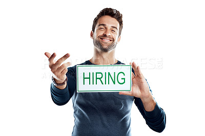 Buy stock photo Studio portrait of a handsome young man holding a hiring sign against a white background