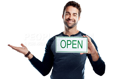 Buy stock photo Studio portrait of a handsome young man holding an open sign against a white background