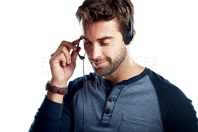 Buy stock photo Studio shot of a handsome young man using a headset against a white background