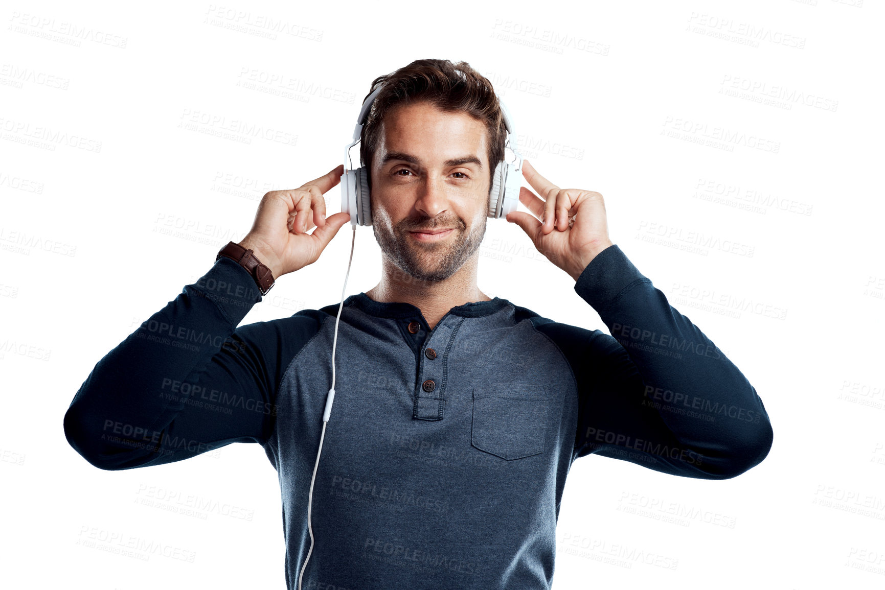 Buy stock photo Studio portrait of a handsome young man using headphones against a white background