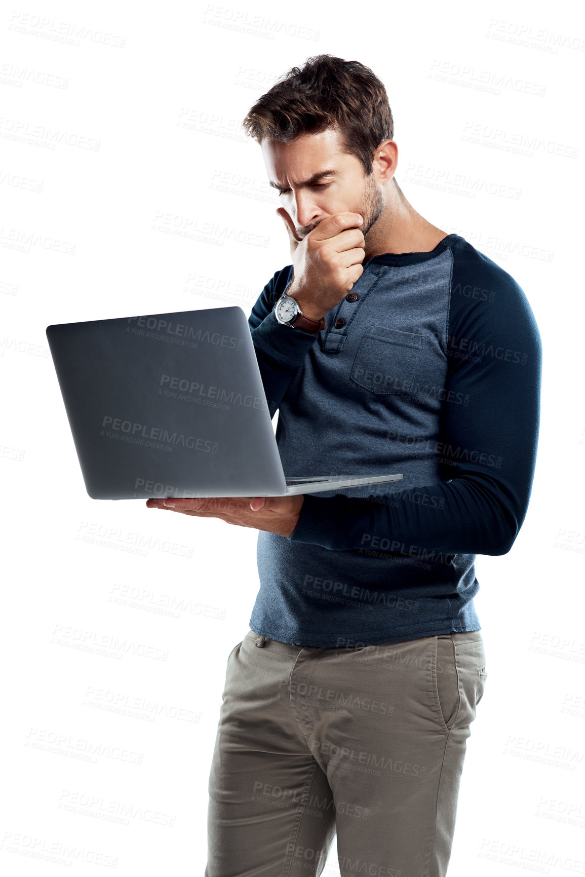 Buy stock photo Studio shot of a handsome young man using a laptop and looking confused against a white background