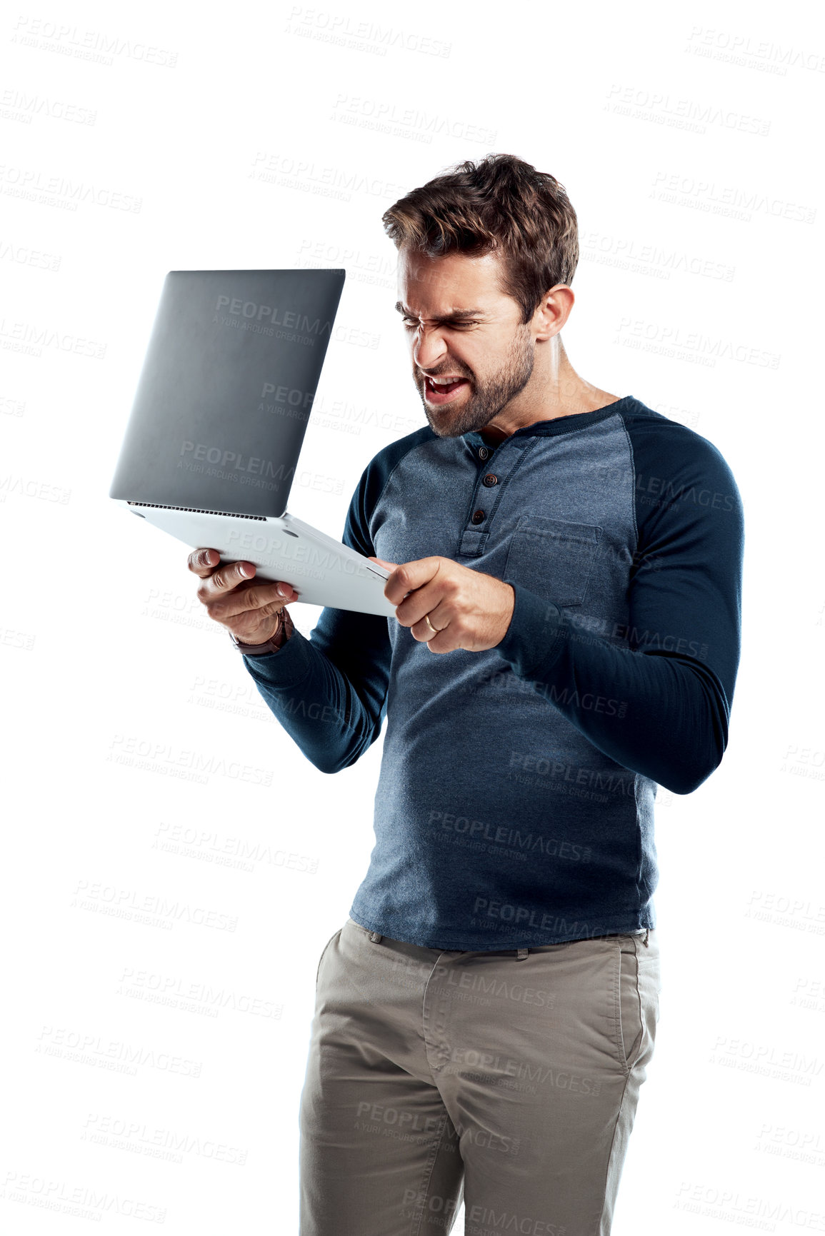 Buy stock photo Studio shot of a handsome young man using a laptop and looking stressed against a white background