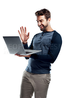 Buy stock photo Studio shot of a handsome young man using a laptop and waving against a white background