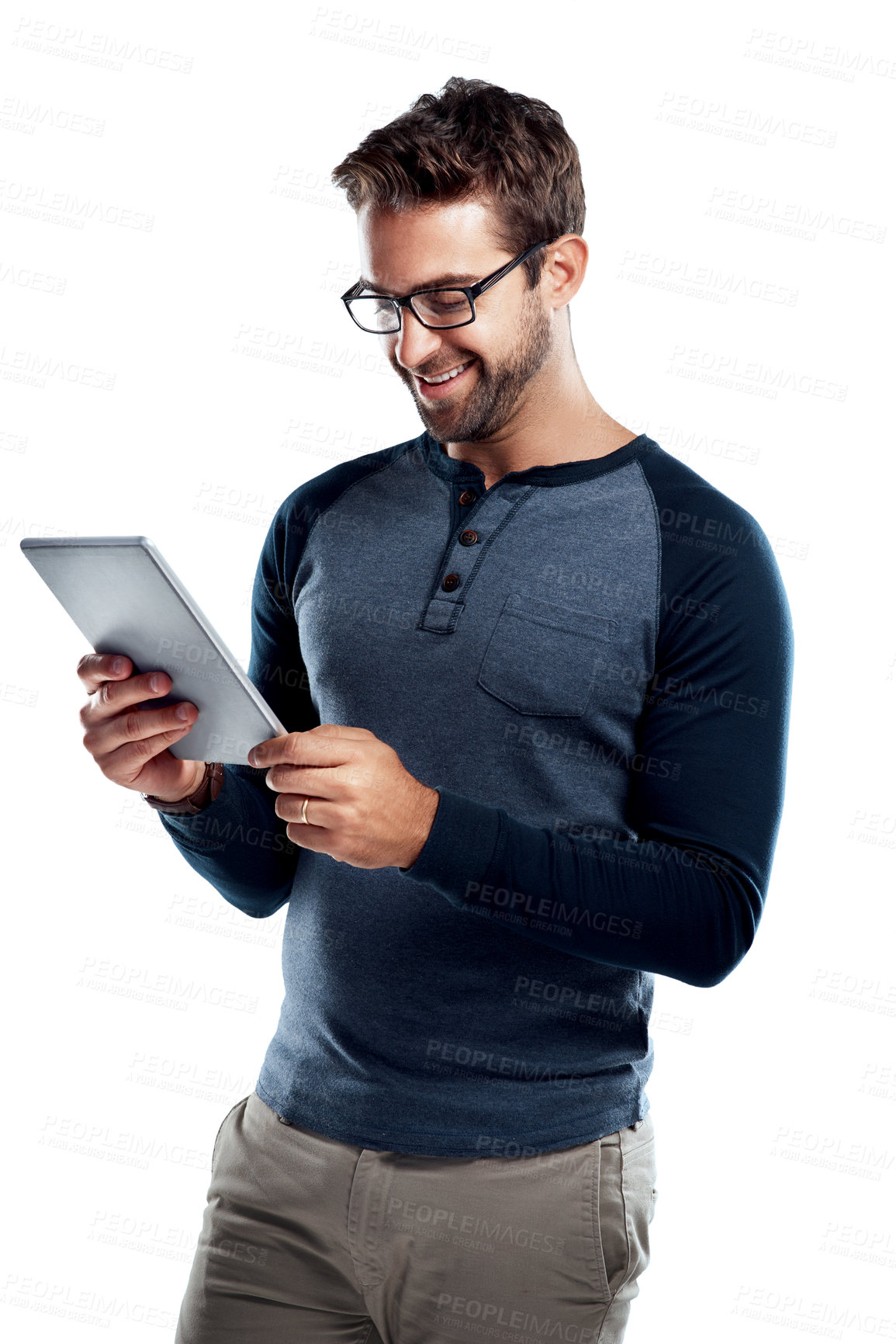 Buy stock photo Studio shot of a handsome young man using a digital tablet against a white background