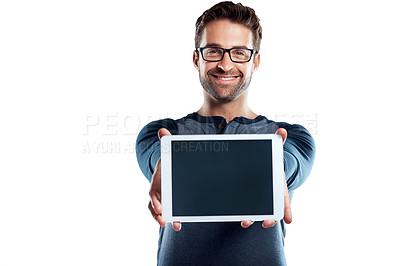 Buy stock photo Studio portrait of a handsome young man holding a digital tablet with a blank screen against a white background