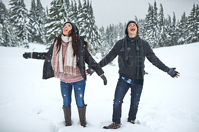 Buy stock photo Couple, happy and playing in snow with freedom for winter adventure, hiking journey and travel. Countryside, people and exploring together in nature with vacation, trekking activity and licking ice