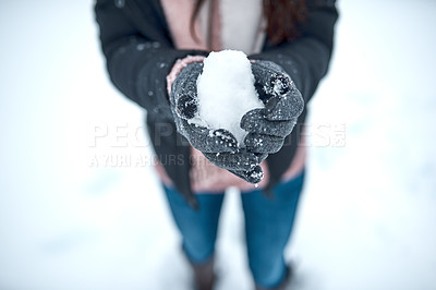 Buy stock photo Cropped shot of an unrecognizable woman holding snow in her hands