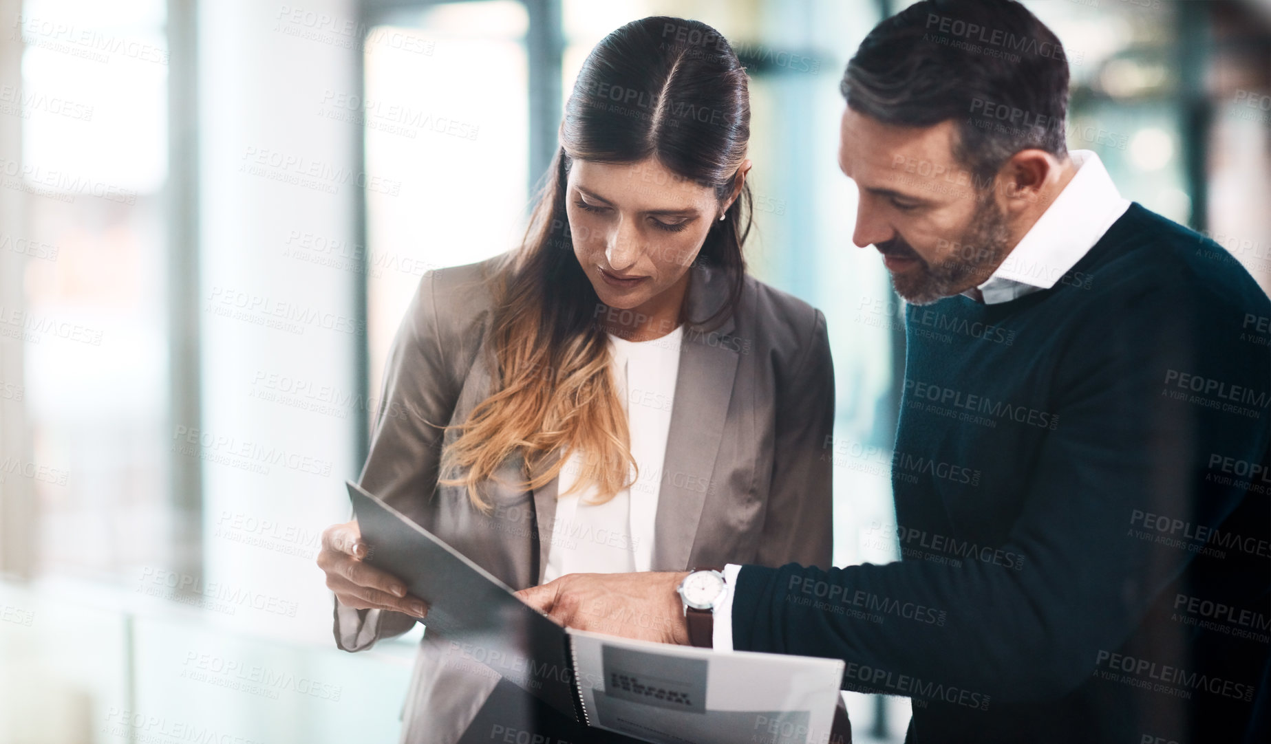 Buy stock photo Man, woman and paperwork with reading in office for teamwork, advice and review for proposal. Business people, partner and attorney for feedback, compliance or conversation for results in workplace