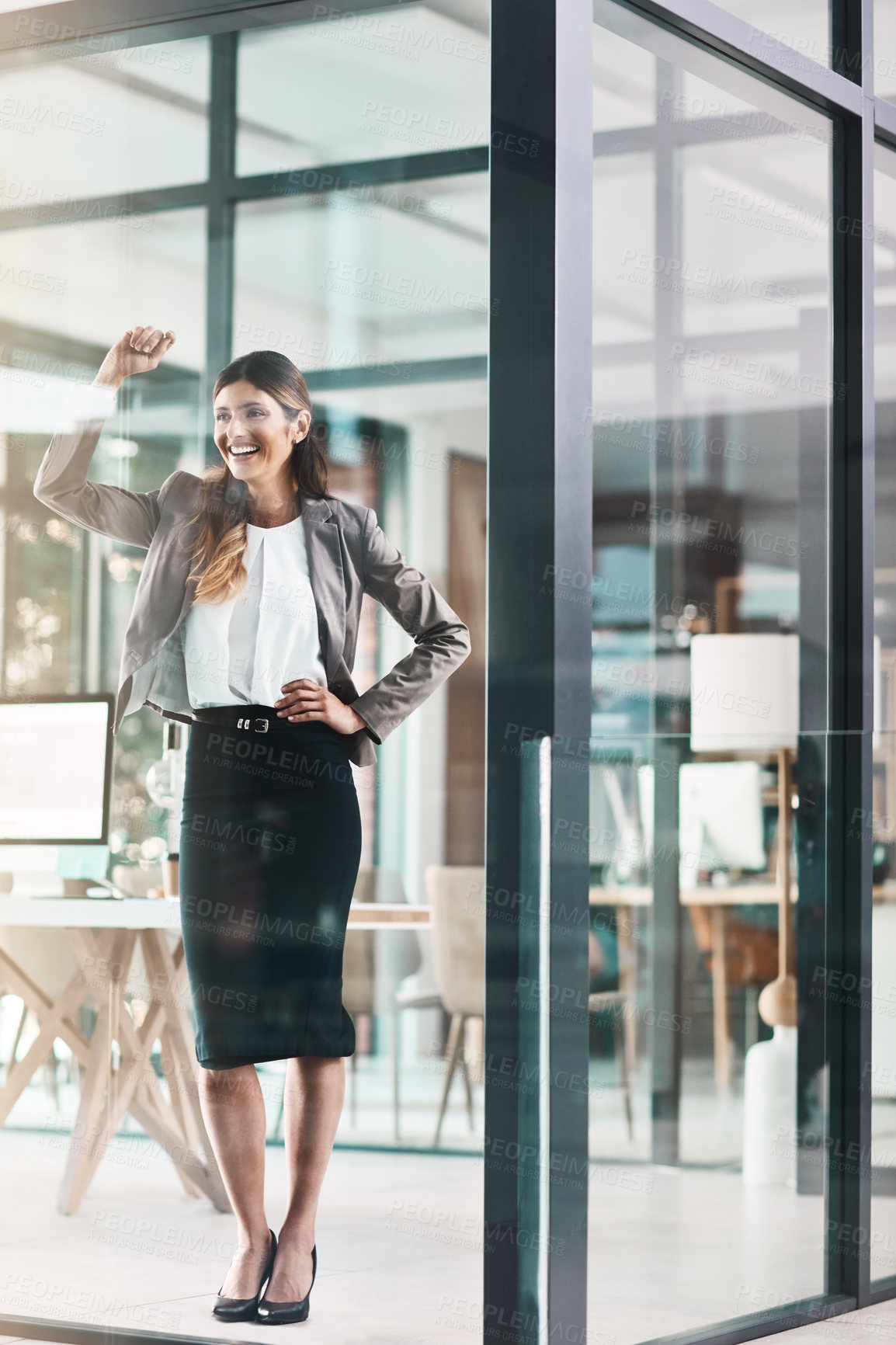 Buy stock photo Shot of a confident young businesswoman working in a modern office