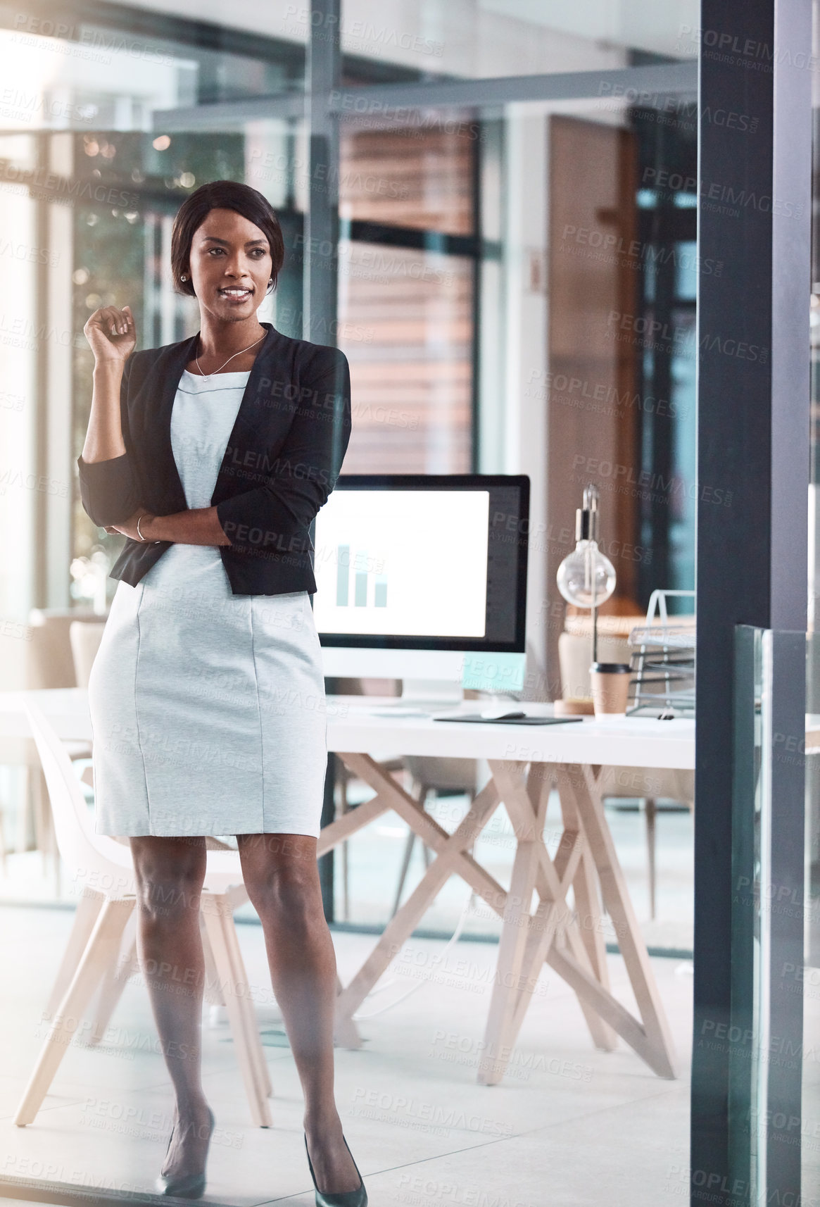 Buy stock photo Shot of a confident young businesswoman working in a modern office