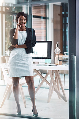 Buy stock photo Shot of a confident young businesswoman working in a modern office