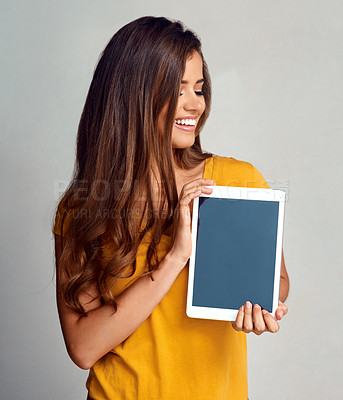 Buy stock photo Happy woman, tablet and advertising with screen for marketing, app or content on a studio background. Female person, brunette or model with smile, technology display or presentation on mockup space