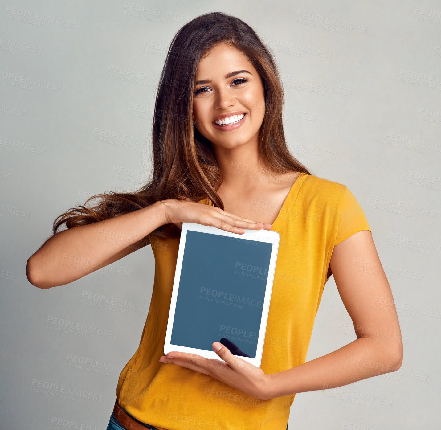 Buy stock photo Happy woman, portrait and tablet with screen for display, advertising or marketing on a studio background. Female person, brunette or model with smile for technology app, presentation or mockup space