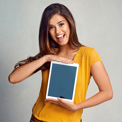 Buy stock photo Excited woman, portrait and tablet with screen for app, advertising or marketing on a studio background. Happy female person or model with smile for technology display, presentation or mockup space