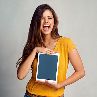 Buy stock photo Excited woman, portrait and display with tablet screen for advertising, marketing or app on a studio background. Happy female person, model or smile for technology or presentation on mockup space