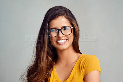 Buy stock photo Studio, confidence and portrait of woman with glasses, smile and positive attitude in trendy fashion. Happy, face and girl in gen z style with pride, vision and eye care wellness on grey background