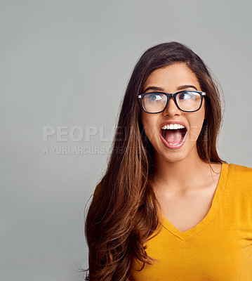 Buy stock photo Studio shot of an attractive young woman looking surprised against a grey background