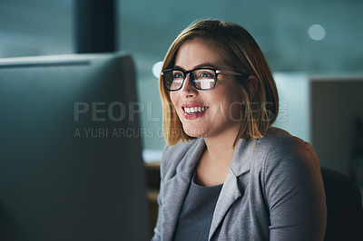 Buy stock photo Shot of a young businesswoman working late on a computer in an office