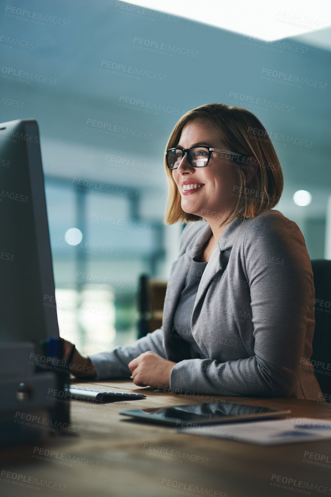 Buy stock photo Office, computer and business woman at night happy for online project, planning and research report. Corporate, professional and person working late on PC for reading email, internet and website