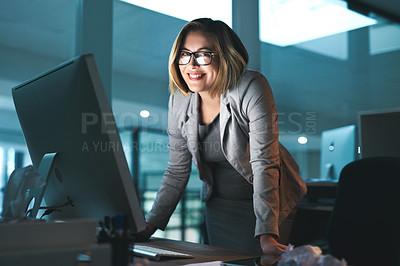 Buy stock photo Portrait of a young businesswoman working late on a computer in an office