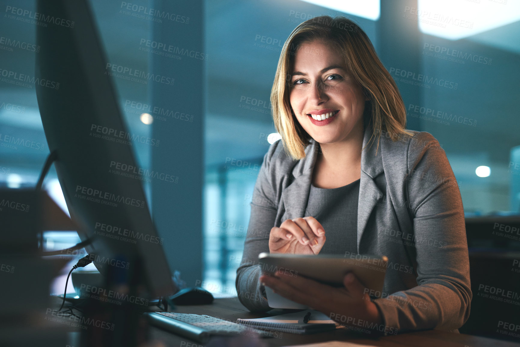 Buy stock photo Portrait of a young businesswoman working late on a digital tablet in an office