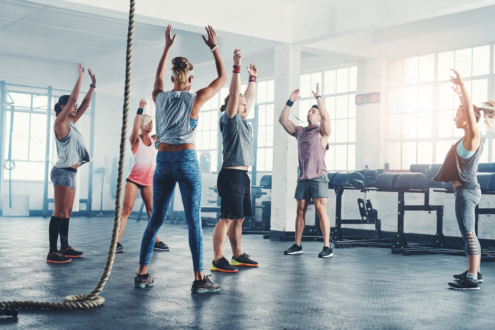 Buy stock photo Stretching, exercise and group of people at gym for training, support and warm up together. Arms raised, fitness and friends with flexibility at health club for endurance, workout and preparation