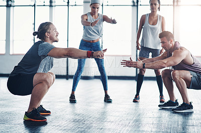 Buy stock photo Shot of a fitness instructor working with a group of people at the gym