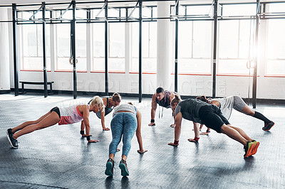 Buy stock photo Shot of an accountability working out while forming a circle at the gym