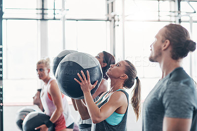 Buy stock photo Shot of a fitness group working out with medicine balls