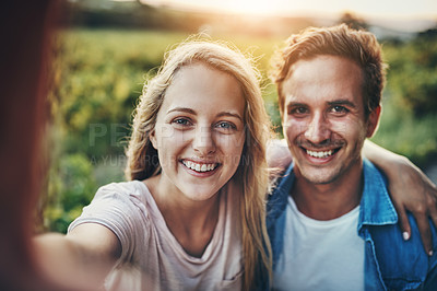 Buy stock photo Cropped portrait of a young couple taking a selfie together with their farmland in the background