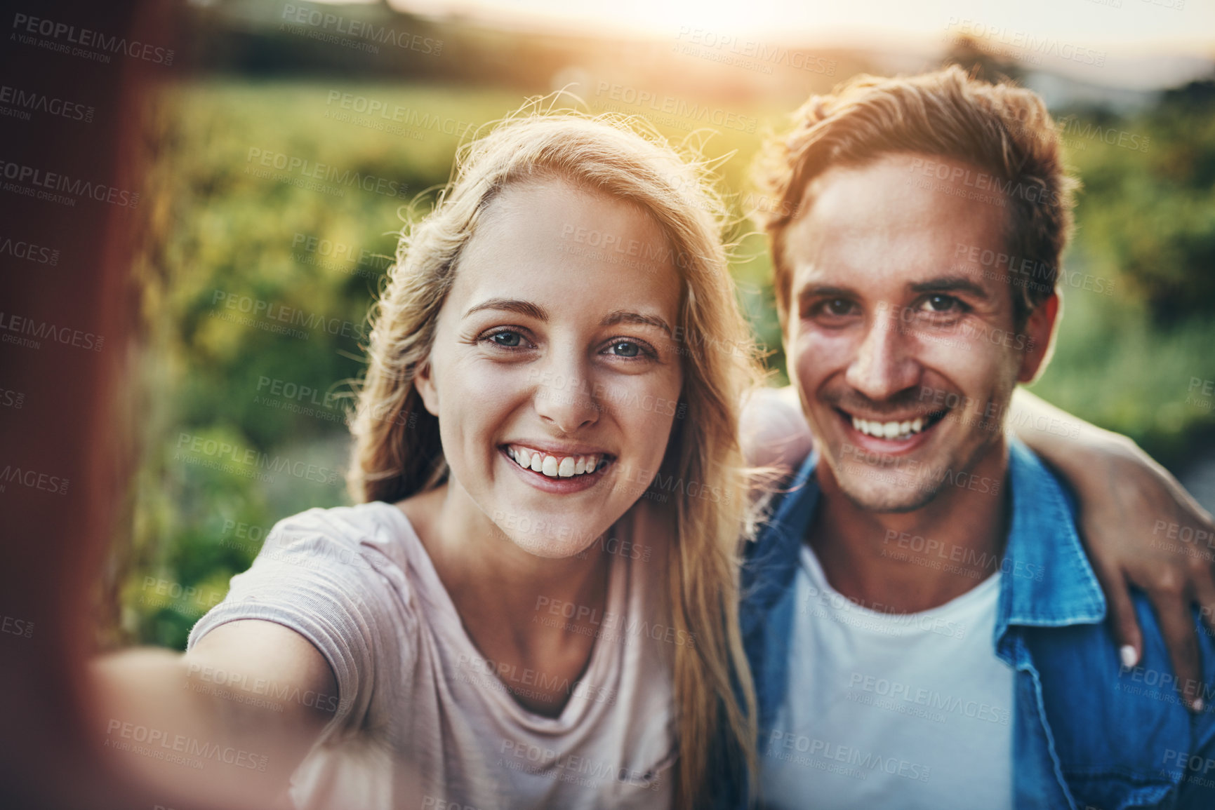 Buy stock photo Cropped portrait of a young couple taking a selfie together with their farmland in the background