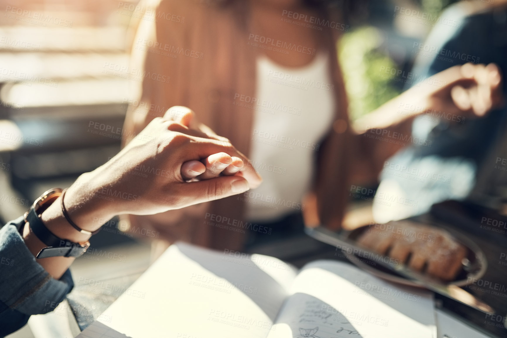 Buy stock photo Cropped shot of a group of creative employees holding hands and praying before breakfast outdoors