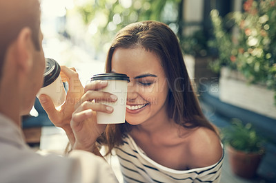 Buy stock photo Cropped shot of two creative employees toasting with coffee cups outside