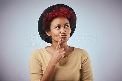Buy stock photo Studio shot of a beautiful young woman contemplating against a grey background