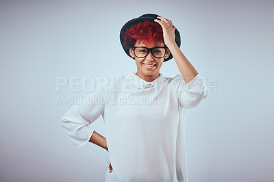 Buy stock photo Studio shot of a beautiful young woman wearing a hat against a grey background