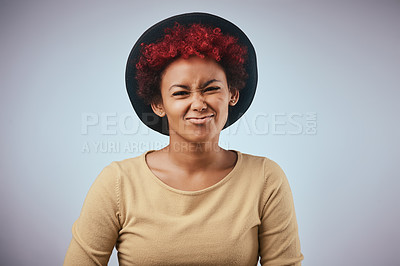 Buy stock photo Studio shot of a beautiful young woman wearing a hat against a grey background
